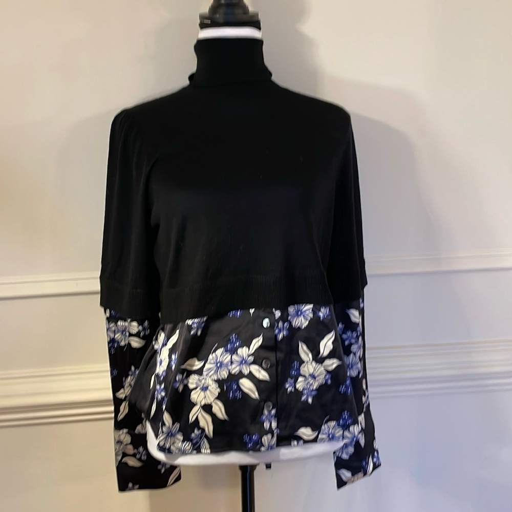 Veronica Beard turtleneck sweater with silk blouse.